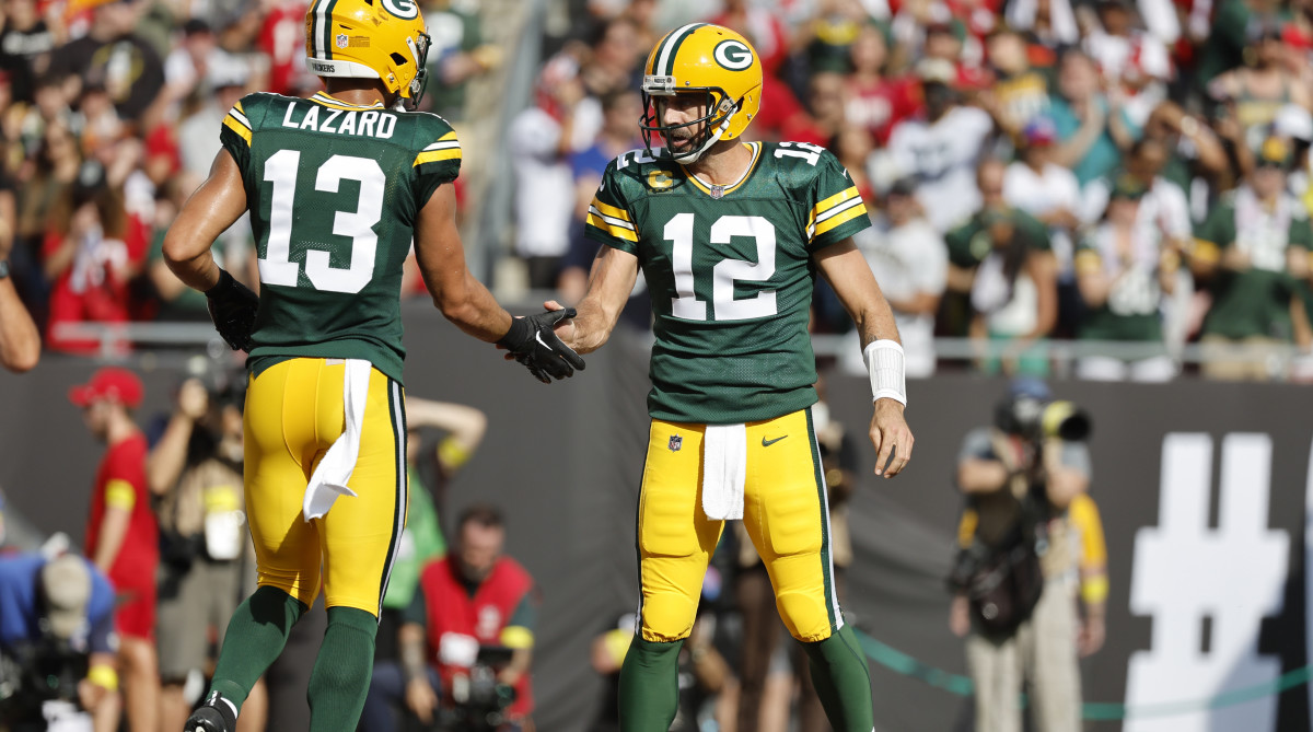 Former Packers WR Allen Lazard high-fives QB Aaron Rodgers.